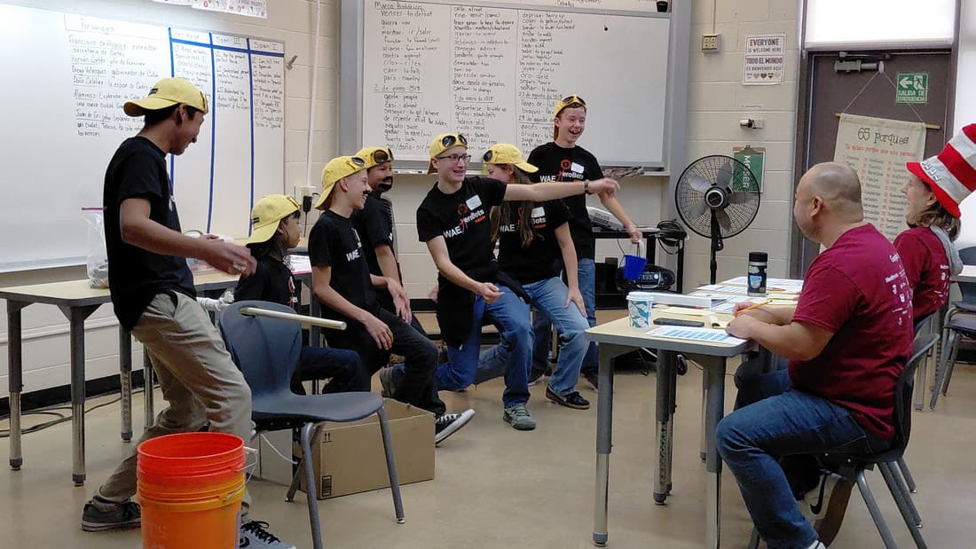 Mission Robotics student team with LEGO robotics table