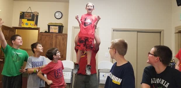 Camper celebrating a robotics build